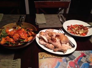 Roast chicken dinner with veggies and salad served family style